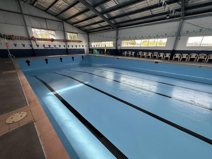 Indoor commercial pool with lane lines, before filling