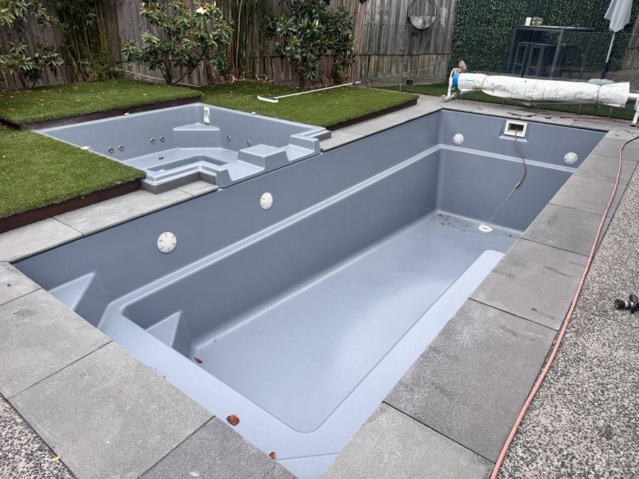 Fibreglass pool with steps resurfaced in grey, before filling