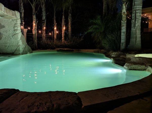 Lagoon-style pool lit at night